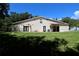 A view of the rear exterior of the home, showing the grassy backyard at 1843 Harbor Blvd, Kissimmee, FL 34744