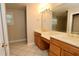 Bathroom featuring double sinks, white tile floors, and ample counterspace at 1843 Harbor Blvd, Kissimmee, FL 34744