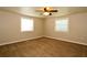 A cozy bedroom featuring two windows for natural light, neutral paint and wall-to-wall carpeting at 1843 Harbor Blvd, Kissimmee, FL 34744