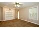 Bedroom with built-in bookshelf, neutral paint and carpet with a window provides natural light at 1843 Harbor Blvd, Kissimmee, FL 34744