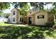 Charming home with a stone facade and mature trees, creating a serene, welcoming environment at 1843 Harbor Blvd, Kissimmee, FL 34744