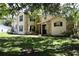 Two-story home boasts a welcoming curb appeal, accented with stone and framed by mature trees at 1843 Harbor Blvd, Kissimmee, FL 34744