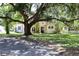 Charming two-story home featuring stone accents, set amongst mature trees for a picturesque curb appeal at 1843 Harbor Blvd, Kissimmee, FL 34744