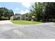 Charming two-story home with stone accents, a well-maintained lawn, and a circular driveway at 1843 Harbor Blvd, Kissimmee, FL 34744