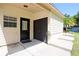 Exterior of the home showing a door to the garage and steps to a side door at 1843 Harbor Blvd, Kissimmee, FL 34744