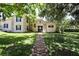 Charming two-story home with stone accents, dark shutters, and a lush lawn at 1843 Harbor Blvd, Kissimmee, FL 34744