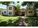 Charming two-story home featuring stone accents, contrasted with a lush green lawn at 1843 Harbor Blvd, Kissimmee, FL 34744