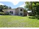 Charming two-story home with stone accents, dark shutters, and a lush lawn at 1843 Harbor Blvd, Kissimmee, FL 34744