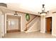 Bright foyer boasts tile flooring, decorative lighting, staircase, and a unique oval window, creating an inviting entrance at 1843 Harbor Blvd, Kissimmee, FL 34744