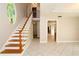 Inviting foyer with tile flooring and staircase with an open entryway leading to other rooms at 1843 Harbor Blvd, Kissimmee, FL 34744