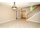 Spacious foyer featuring tile flooring, elegant lighting, and a staircase, offering a welcoming entrance to the home at 1843 Harbor Blvd, Kissimmee, FL 34744