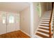 Welcoming foyer featuring hardwood floors, staircase, and unique round window allowing for lots of natural light at 1843 Harbor Blvd, Kissimmee, FL 34744
