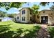 Two-story home with stone details, and a brick walkway leading to the front door at 1843 Harbor Blvd, Kissimmee, FL 34744