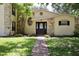 Charming home with stone accents, a brick pathway, and lush landscaping at 1843 Harbor Blvd, Kissimmee, FL 34744