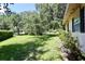 Spacious front yard with mature trees, green grass, and landscaping at 1843 Harbor Blvd, Kissimmee, FL 34744