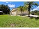 Three-car garage, palm trees and a large grassy yard at 1843 Harbor Blvd, Kissimmee, FL 34744