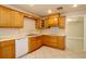 Well-lit kitchen with wood cabinetry, and white appliances, offering a practical and efficient cooking environment at 1843 Harbor Blvd, Kissimmee, FL 34744
