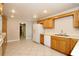 Spacious kitchen includes wood cabinets, white appliances, and tile floors providing functional cooking space at 1843 Harbor Blvd, Kissimmee, FL 34744