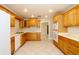 Bright kitchen features wood cabinets, white appliances, and tile flooring, creating a functional cooking space at 1843 Harbor Blvd, Kissimmee, FL 34744