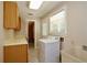 Laundry room features a washer, utility sink, and storage cabinets, offering convenience and organization at 1843 Harbor Blvd, Kissimmee, FL 34744