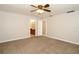 Spacious bedroom featuring neutral paint, carpet, and ceiling fan with an ensuite bathroom at 1843 Harbor Blvd, Kissimmee, FL 34744