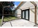View of back patio area with access to the house through double glass doors at 1843 Harbor Blvd, Kissimmee, FL 34744