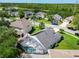 Aerial view of a neighborhood featuring a screened pool and beautiful green landscaping at 1851 Hammock Moss Dr, Orlando, FL 32820