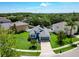Aerial view of a well-maintained home with palm trees, fenced yard, and a two-car garage at 1851 Hammock Moss Dr, Orlando, FL 32820