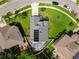 An aerial view of a house with solar panels, a pool and a screened in enclosure at 1851 Hammock Moss Dr, Orlando, FL 32820