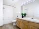 Bathroom featuring a tub and shower combination and a wooden vanity at 1851 Hammock Moss Dr, Orlando, FL 32820