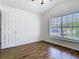 Bedroom featuring wood flooring and a double hung window at 1851 Hammock Moss Dr, Orlando, FL 32820