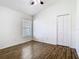 An empty bedroom featuring wood flooring, a ceiling fan and a double door closet at 1851 Hammock Moss Dr, Orlando, FL 32820