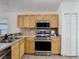 Kitchen featuring stainless steel oven, microwave, and light wood cabinetry at 1851 Hammock Moss Dr, Orlando, FL 32820