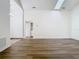 Large, empty living room featuring hardwood floors and access to the laundry room at 1851 Hammock Moss Dr, Orlando, FL 32820