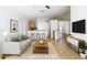 Staged living room showcasing an open floor plan that connects to the kitchen and dining area at 1851 Hammock Moss Dr, Orlando, FL 32820