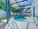 Outdoor living space featuring a screened-in pool area with nice landscaping at 1851 Hammock Moss Dr, Orlando, FL 32820