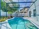 Beautiful pool area with a screened enclosure and a decorative tiled edge at 1851 Hammock Moss Dr, Orlando, FL 32820