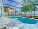 Screened-in pool with a sunny pool deck and attractive landscaping at 1851 Hammock Moss Dr, Orlando, FL 32820