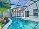 Relaxing screened-in pool with a blue-tile trim and a view of the backyard at 1851 Hammock Moss Dr, Orlando, FL 32820