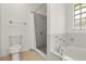 Bathroom with a tiled shower, commode, soaking tub with jets, and a glass block window for natural light at 1914 Ellery Ln, Kissimmee, FL 34746
