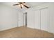Bedroom with a ceiling fan, and closet, with neutral tile flooring at 1914 Ellery Ln, Kissimmee, FL 34746