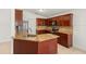 Updated kitchen with granite countertops, stainless steel appliances, and wooden cabinets at 1914 Ellery Ln, Kissimmee, FL 34746