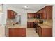 Updated kitchen with granite countertops, stainless steel appliances, and wooden cabinets at 1914 Ellery Ln, Kissimmee, FL 34746