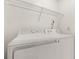 Laundry room featuring white washer, dryer, and overhead wire shelving at 1914 Ellery Ln, Kissimmee, FL 34746