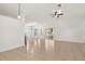 Spacious living room featuring tile floors, ceiling fan, and sliding glass doors at 1914 Ellery Ln, Kissimmee, FL 34746