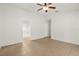 Main bedroom featuring tile floors, ceiling fan, and an ensuite bathroom at 1914 Ellery Ln, Kissimmee, FL 34746