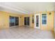 Covered patio featuring tile flooring and sliding door access to the home's interior at 1914 Ellery Ln, Kissimmee, FL 34746