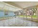 Enclosed lanai featuring a tile floor and screened windows overlooking the yard at 1914 Ellery Ln, Kissimmee, FL 34746