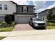 Modern home featuring a brick-paved driveway and a spacious two-car garage at 2086 Crape Jasmine Ln, Orlando, FL 32824