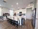 Bright kitchen features a large center island with seating and modern white cabinetry at 2086 Crape Jasmine Ln, Orlando, FL 32824